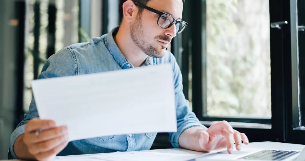 man considering the tax implications of buying an investment property