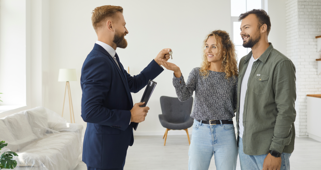 couple receiving keys to their new investment property