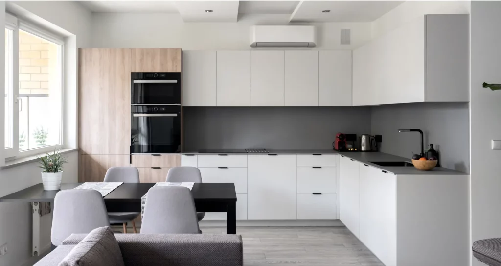 a kitchen with white cabinets and a table